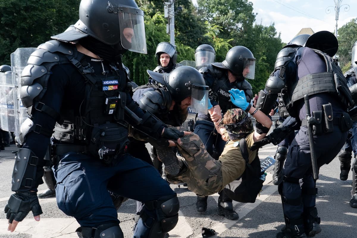 Protester detained by Police in Bucharest.