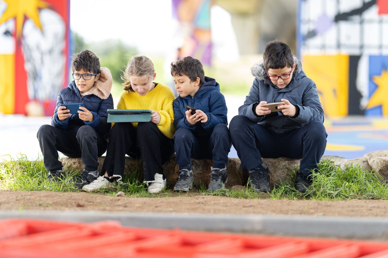 Children using tech outdoors