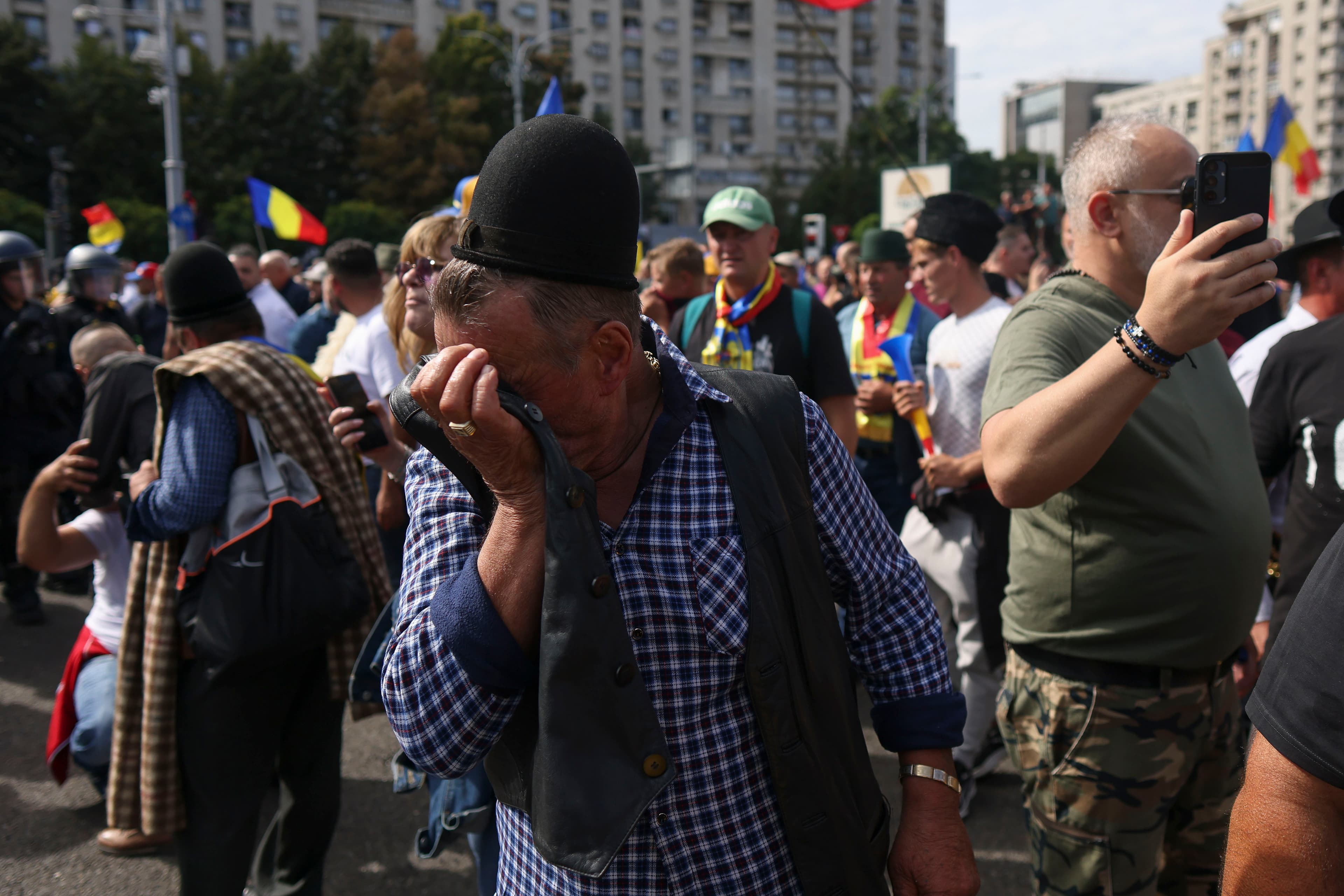 Shepherds and protesters affected by tear gas during protest in Bucharest.