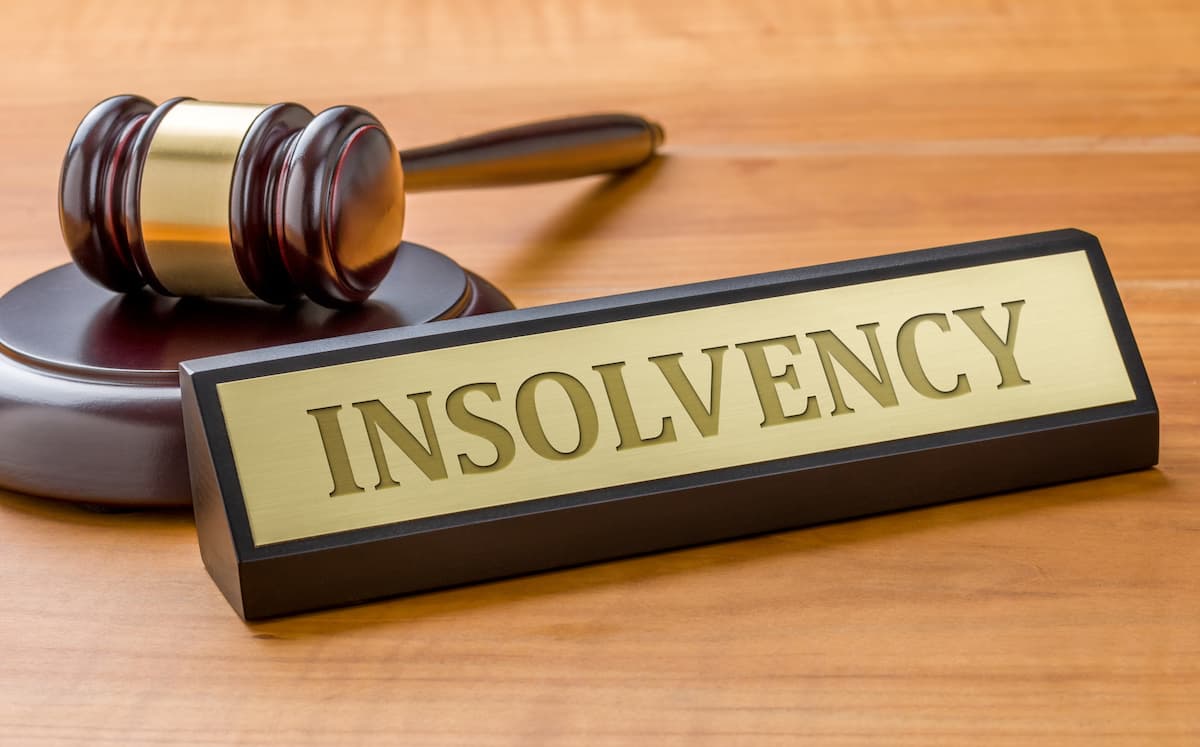 Insolvency sign placed near judge gavel.