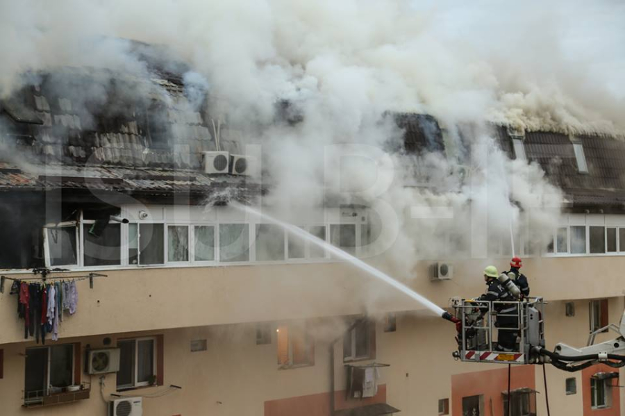 Some 400 evacuated as the attic of an apartment building catches fire ...